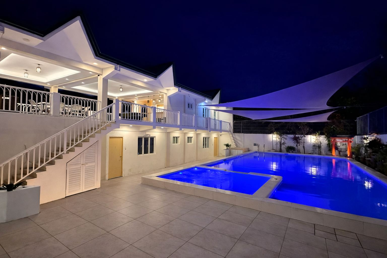 Hot spring pool at night under sail shades